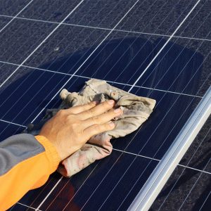 Solar Panel Cleaning Services in Hertfordshire - Solar Panel being cleaned by hand